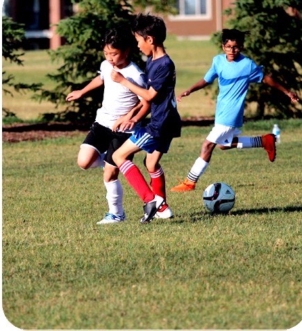 three-boys-playing-soccer